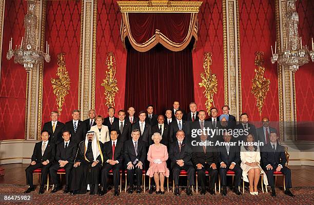 Queen Elizabeth II with delegates of the G20 London summit pose for a group picture in the Throne Room at Buckingham Palace on April 1, 2009 in...