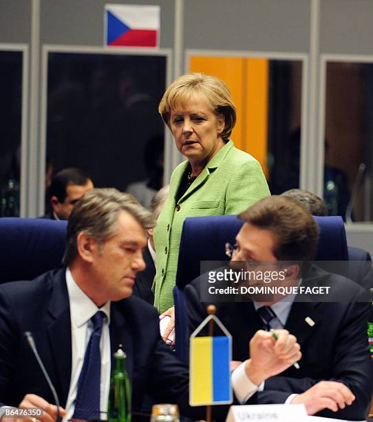 German Chancellor Angela Merkel looks at Ukrainian President Viktor Yushenko and Moldovan Foreign Minister Andrei Stratan on May 7, 2009 before an...