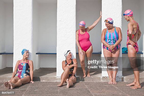 group of friends talking by pool side - swimming cap stock pictures, royalty-free photos & images