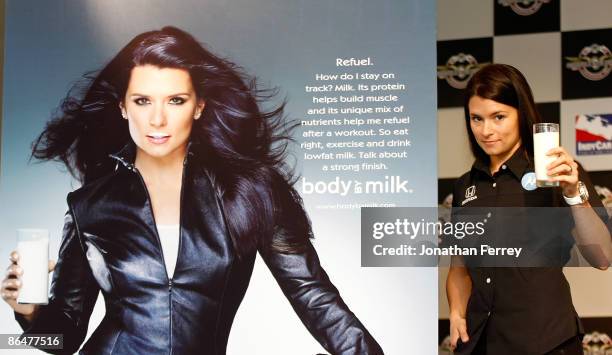 Danica Patrick driver of the Motorola Andretti Green Racing Dallara Honda poses with some milk beside her new "Got Milk?" ad campaign poster before...