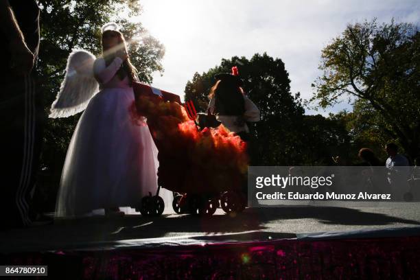 Woman and her dog in costumes attend the 27th Annual Tompkins Square Halloween Dog Parade in Tompkins Square Park on October 21, 2017 in New York...