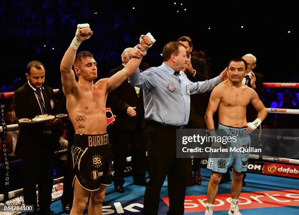 Ryan Burnett of Northern Ireland is declared the winner after his bout with Zhanat Zhakiyanov of Kazakhstan for the IBF, WBO and IBO World...