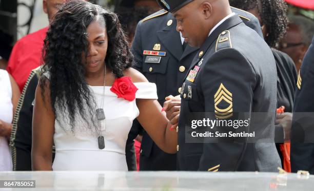 Myeshia Johnson, the wife of Army Sgt. La David Johnson, looks down at his casket during his burial at Fred Hunter's Hollywood Memorial Gardens in...