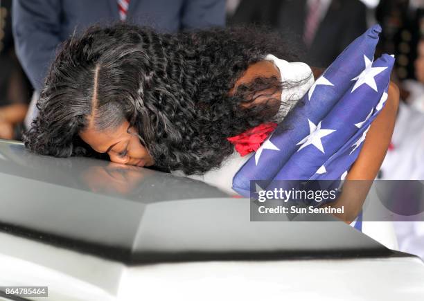 Myeshia Johnson, the wife of Army Sgt. La David Johnson, kisses her husband's casket during his burial at Fred Hunter's Hollywood Memorial Gardens in...