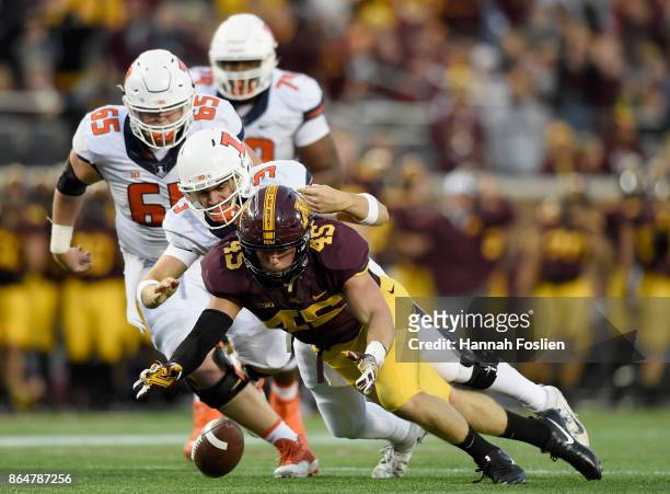 Carter Coughlin of the Minnesota Golden Gophers and Jeff George Jr. #3 of the Illinois Fighting Illini go after a loose ball during the fourth...