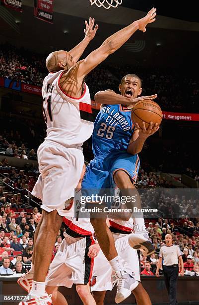 Earl Watson of the Oklahoma City Thunder goes to the basket under pressure against Michael Ruffin of the Portland Trail Blazers during the game on...