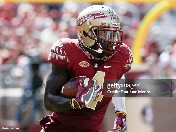 Cornerback Tarvarus McFadden of the Florida State Seminoles returns a punt back during the game against the Louisville Cardinals at Doak Campbell...