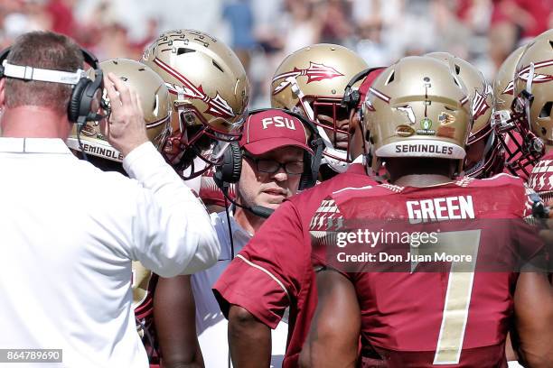 Head Coach Jimbo Fisher of the Florida State Seminoles talk with his team on a timeout during the game against the Louisville Cardinals at Doak...
