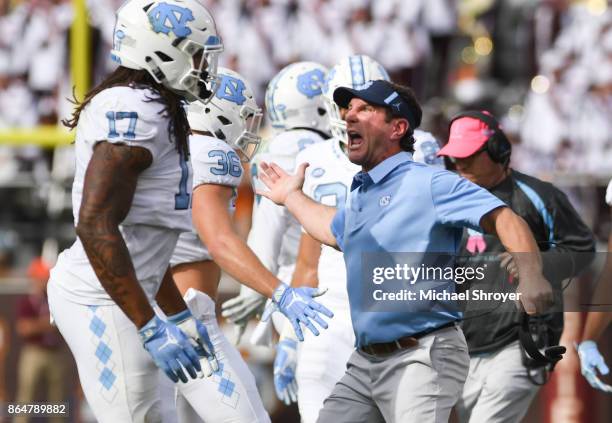 Head coach Larry Fedora of the North Carolina Tar Heels reacts with linebacker Cole Holcomb in the first half against the Virginia Tech Hokies at...