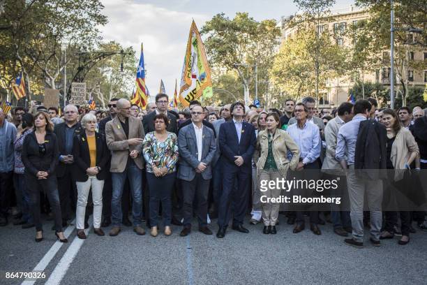 Carles Puigdemont, Catalonia's president, center right, participates in a demonstration against the Spanish government and the imprisonment of...