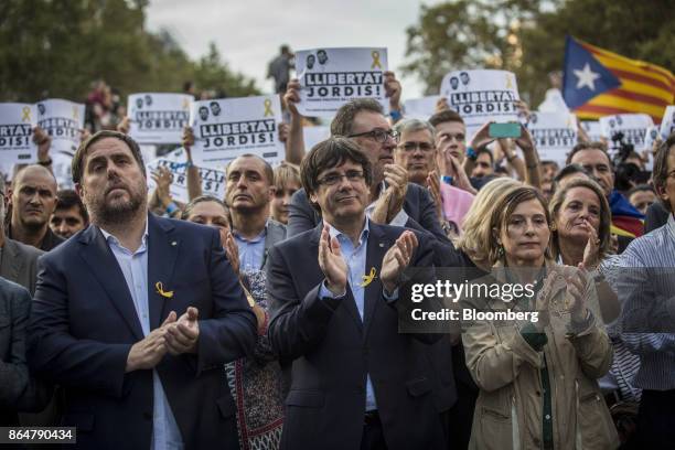 Carles Puigdemont, Catalonia's president, center, applauds during a demonstration against the Spanish government and the imprisonment of separatist...