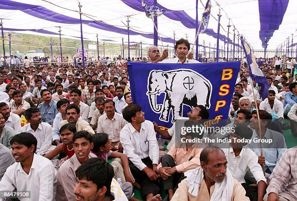 Supporter flaunts a BSP flag at Mayawati's election rally on May 3, 2009 at Ramlila Ground, India. India is the world's largest democracy and voting...
