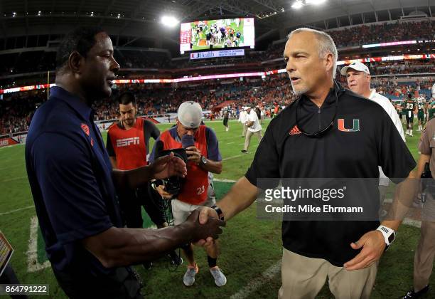 Miami Hurricanes head coach Mark Richt shakes hands with Syracuse Orange head coach Dino Babers during a game at Sun Life Stadium on October 21, 2017...