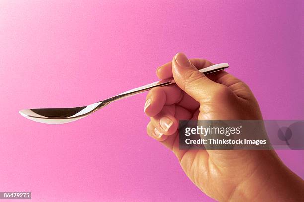 hand holding teaspoon - spoon in hand ストックフォトと画像