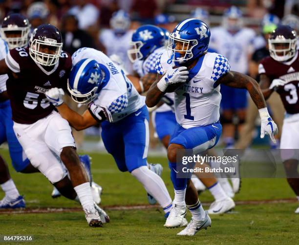 Lynn Bowden Jr. #1 of the Kentucky Wildcats tries to find a hole as he carries the ball during the second half of an NCAA football game against the...