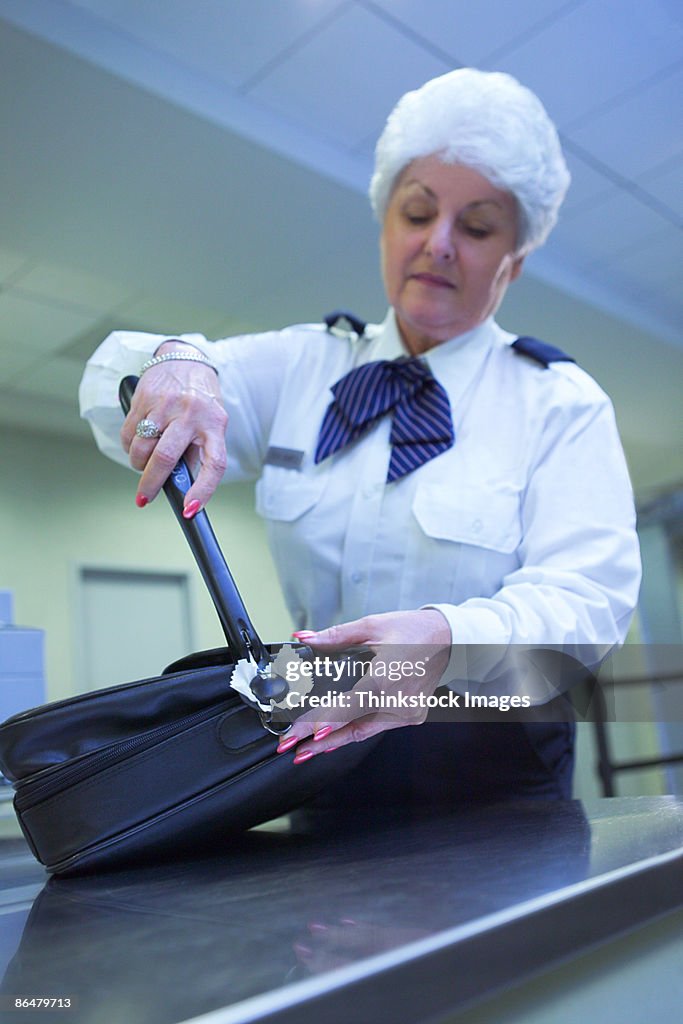 Airport security officer checking luggage