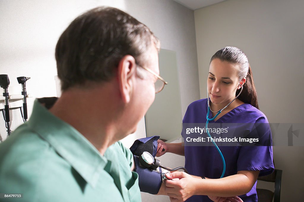 Nurse taking patients blood pressure