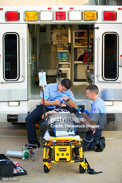 paramedic incubating patient - hospital gurney stock pictures, royalty-free photos & images