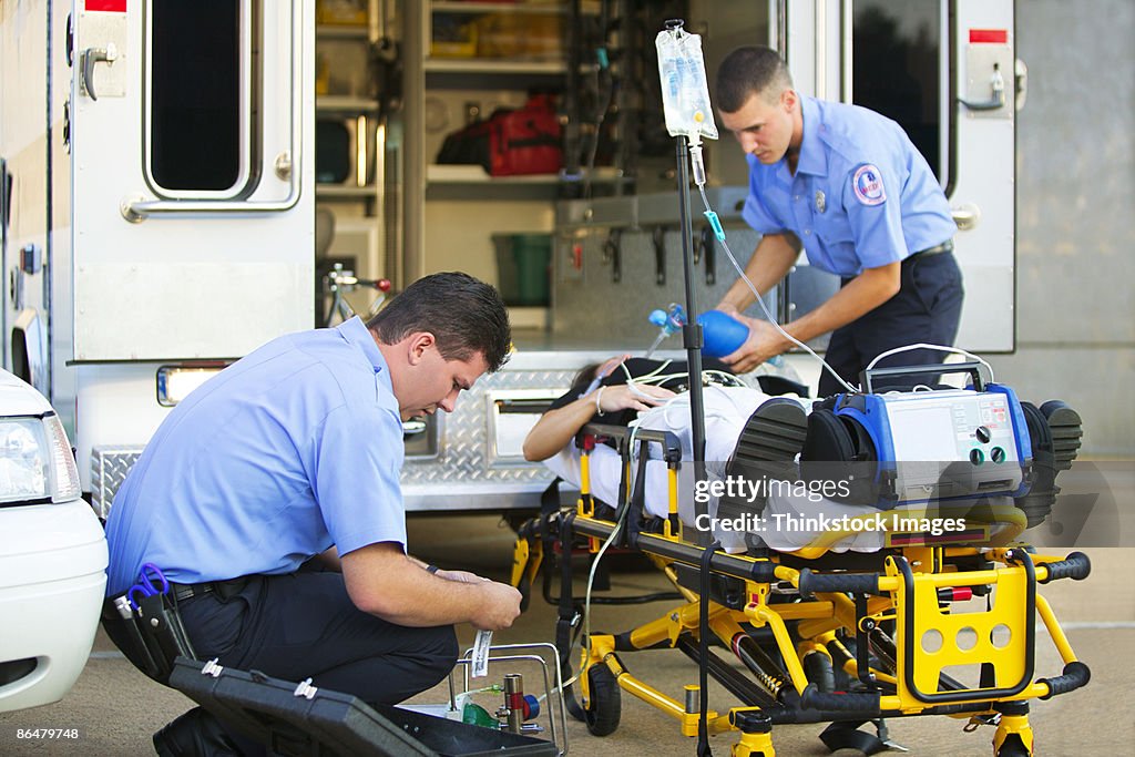 Paramedics loading patient into ambulance