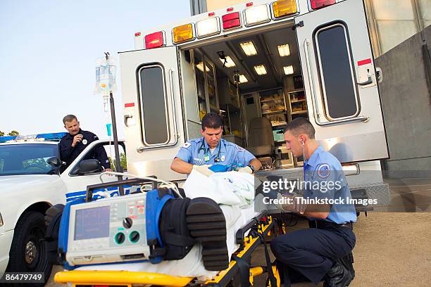 paramedics loading patient into ambulance - emergency services occupation ストックフォトと画像