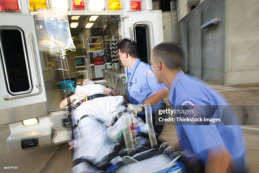 Paramedics loading patient into ambulance