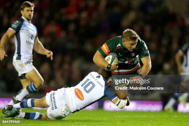Tom Youngs of Leicester Tigers is tackled by Yohan Le Bouhuis during the European Rugby Champions Cup match between Leicester Tigers and Castres...