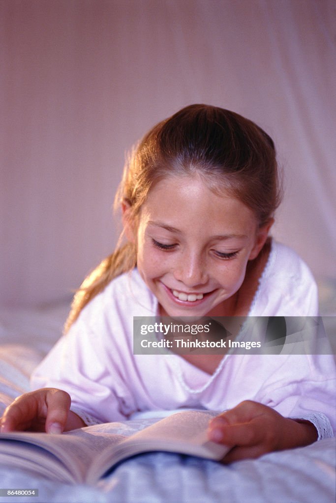 Girl reading in bed