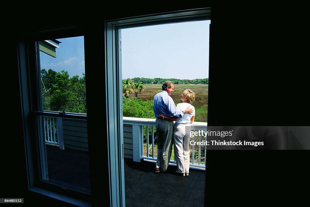 Couple on porch of home
