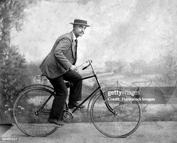 vintage image of man riding bicycle - bicicleta vintage imagens e fotografias de stock