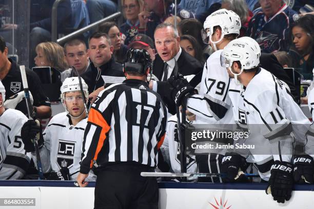 Assistant Coach Dave Lowry of the Los Angeles Kings talks with referee Frederick L'Ecuyer following a play during the second period of a game between...