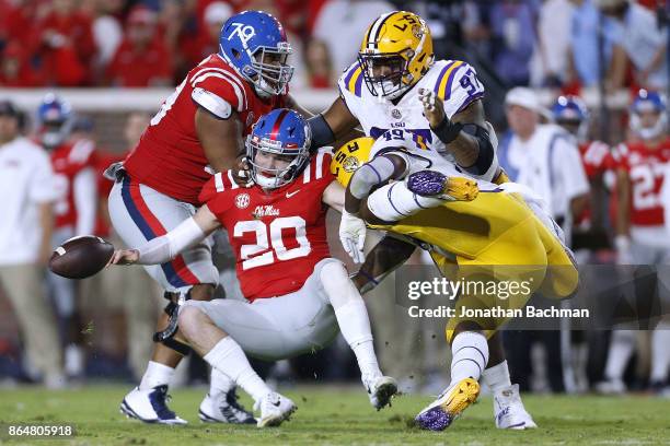 Arden Key of the LSU Tigers forces a fumble on Shea Patterson of the Mississippi Rebels during the first half of a game at Vaught-Hemingway Stadium...