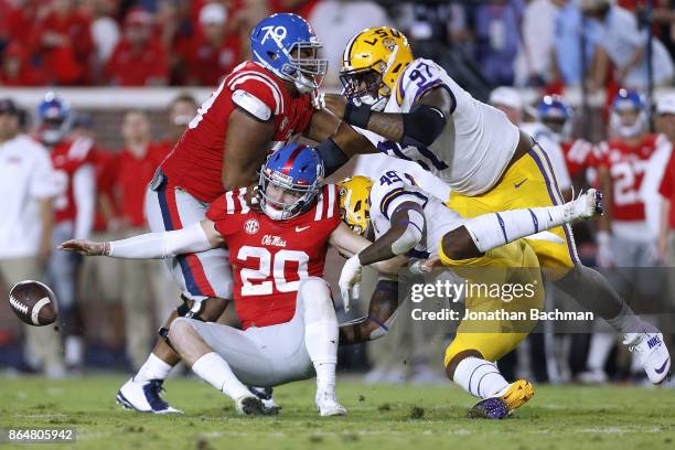 Arden Key of the LSU Tigers forces a fumble on Shea Patterson of the Mississippi Rebels during the first half of a game at Vaught-Hemingway Stadium...