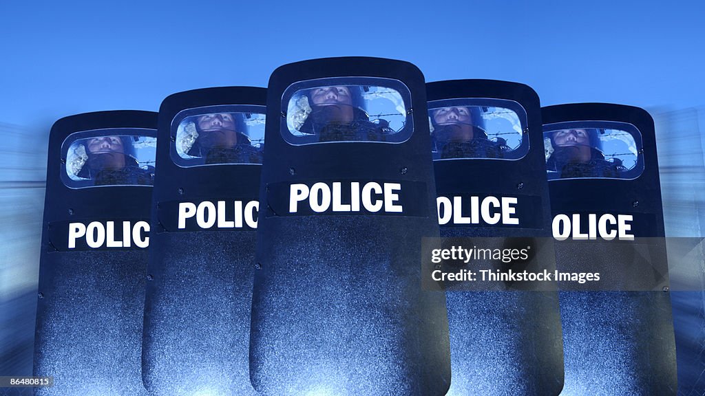 Policemen behind shields