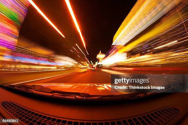 motion blur of car driving down street - las vegas street stock pictures, royalty-free photos & images