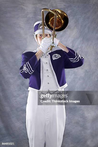 trombone player in marching band - marching band stock pictures, royalty-free photos & images