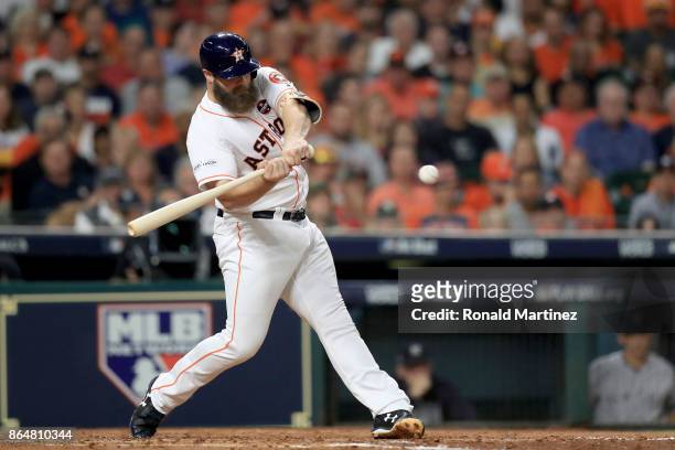 Evan Gattis of the Houston Astros hits a a solo home run against CC Sabathia of the New York Yankees during the fourth inning in Game Seven of the...