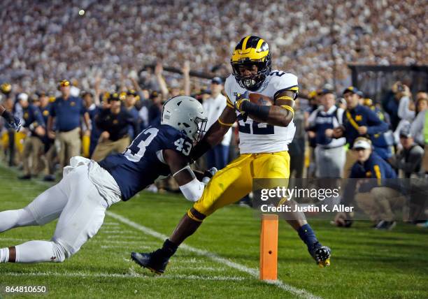 Karan Higdon of the Michigan Wolverines rushes for a 1 yard touchdown against Manny Bowen of the Penn State Nittany Lions on October 21, 2017 at...