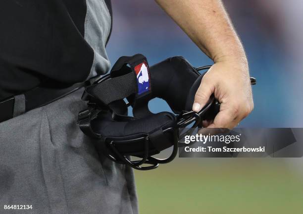 Home plate umpire Eric Cooper holds his mask by his side during the Toronto Blue Jays MLB game against the Tampa Bay Rays at Rogers Centre on August...