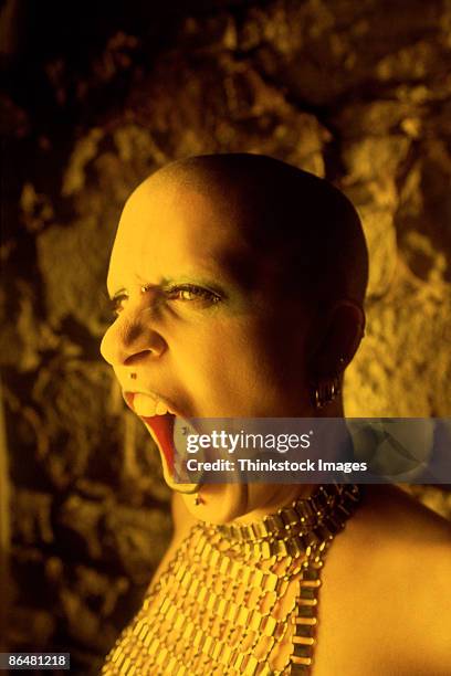 woman with piercings screaming - tongue stud stock pictures, royalty-free photos & images