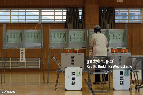 Woman fills out her ballot to vote in parliament's lower house election at a polling station on October 22, 2017 in Himeji, Japan. Prime Minister...