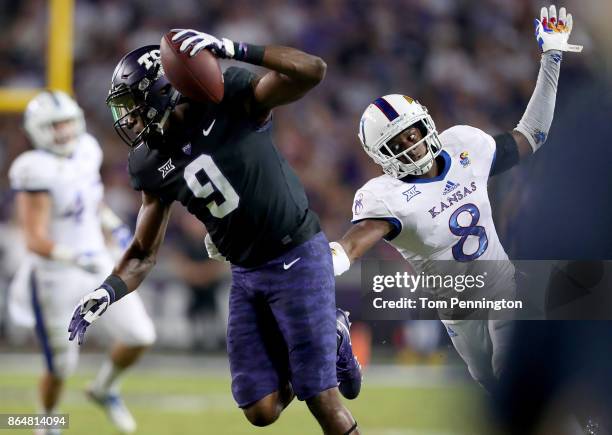 John Diarse of the TCU Horned Frogs pulls in a touchdown pass against Shakial Taylor of the Kansas Jayhawks in the first half at Amon G. Carter...