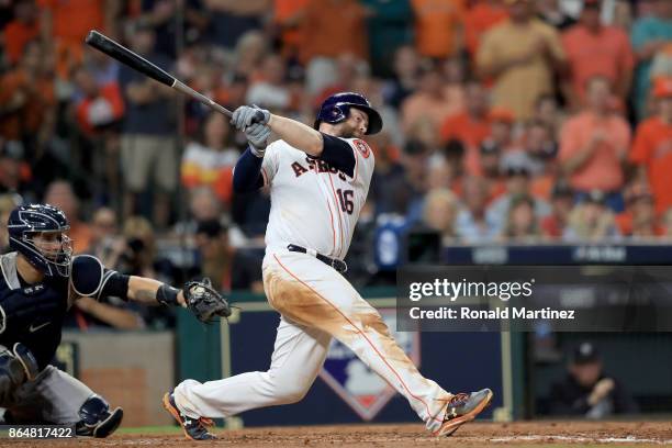 Brian McCann of the Houston Astros hits a double to right field to score Carlos Correa and Yuli Gurriel against Tommy Kahnle of the New York Yankees...