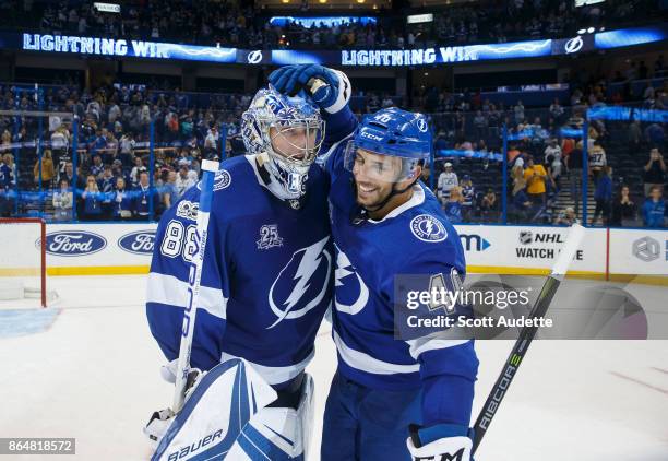 Goalie Andrei Vasilevskiy and Gabriel Dumont of the Tampa Bay Lightning celebrate the win against the Pittsburgh Penguins at Amalie Arena on October...