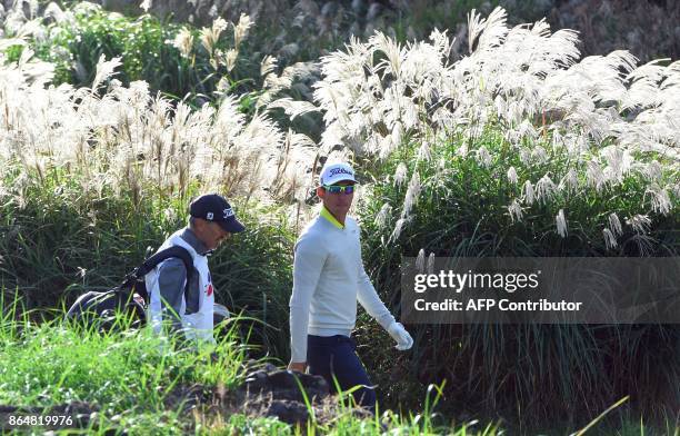 Rafa Cabrera Bello of Spain and his caddy walk the fairway on the 1st hole during the final round of the CJ Cup at Nine Bridges in Jeju Island on...