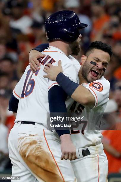 Brian McCann and Jose Altuve of the Houston Astros celebrate after hitting a double to right field to score Carlos Correa and Yuli Gurriel against...