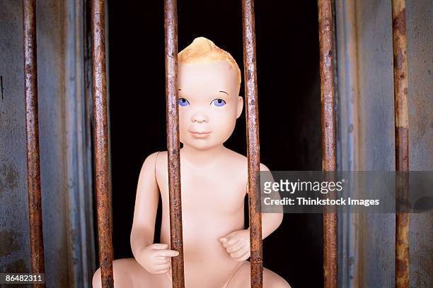 doll behind bars - kewpie doll stock-fotos und bilder