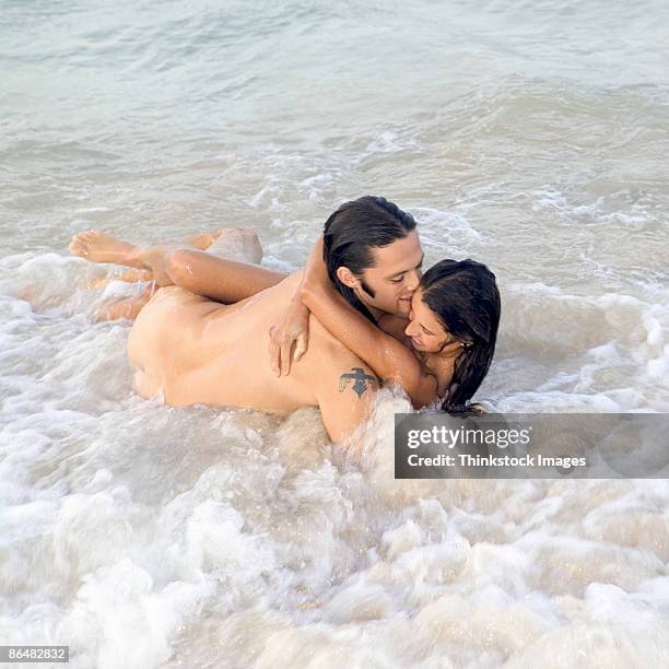 nude couple in ocean - skinny dipping stock-fotos und bilder