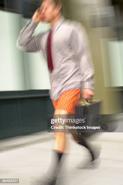 businessman without pants walking with briefcase - schocktaktik stock-fotos und bilder