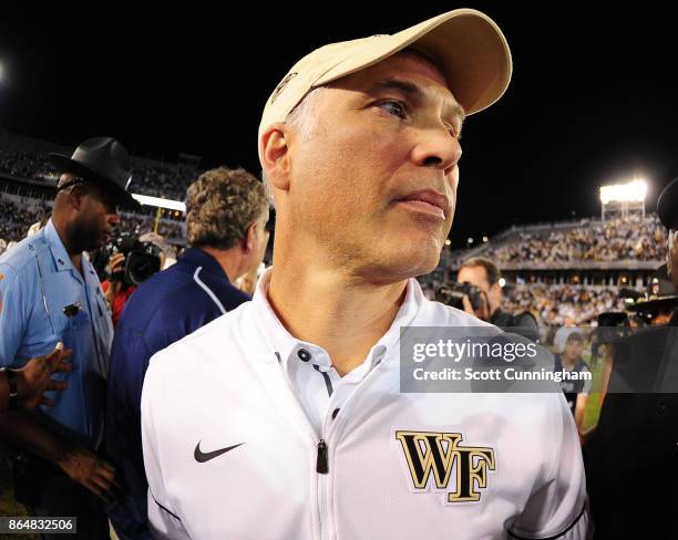 Head Coach Dave Clawson of the Wake Forest Deamon Deacons heads off the field after congratulating Head Coach Paul Johnson of the Georgia Tech Yellow...