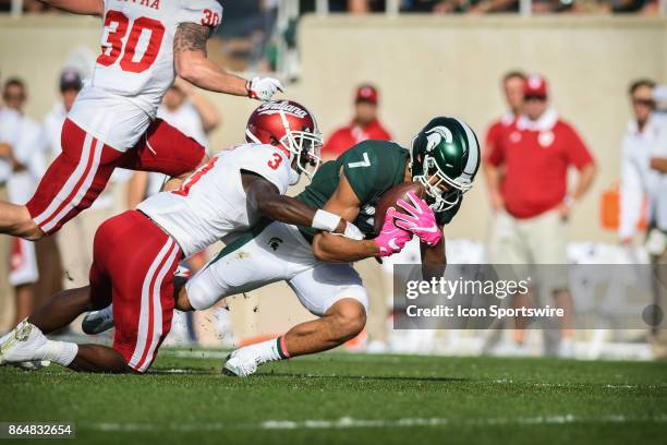 Spartans wide receiver Cody White gets dragged down by Hoosiers cornerback Tyler Green during a Big Ten Conference NCAA football game between...